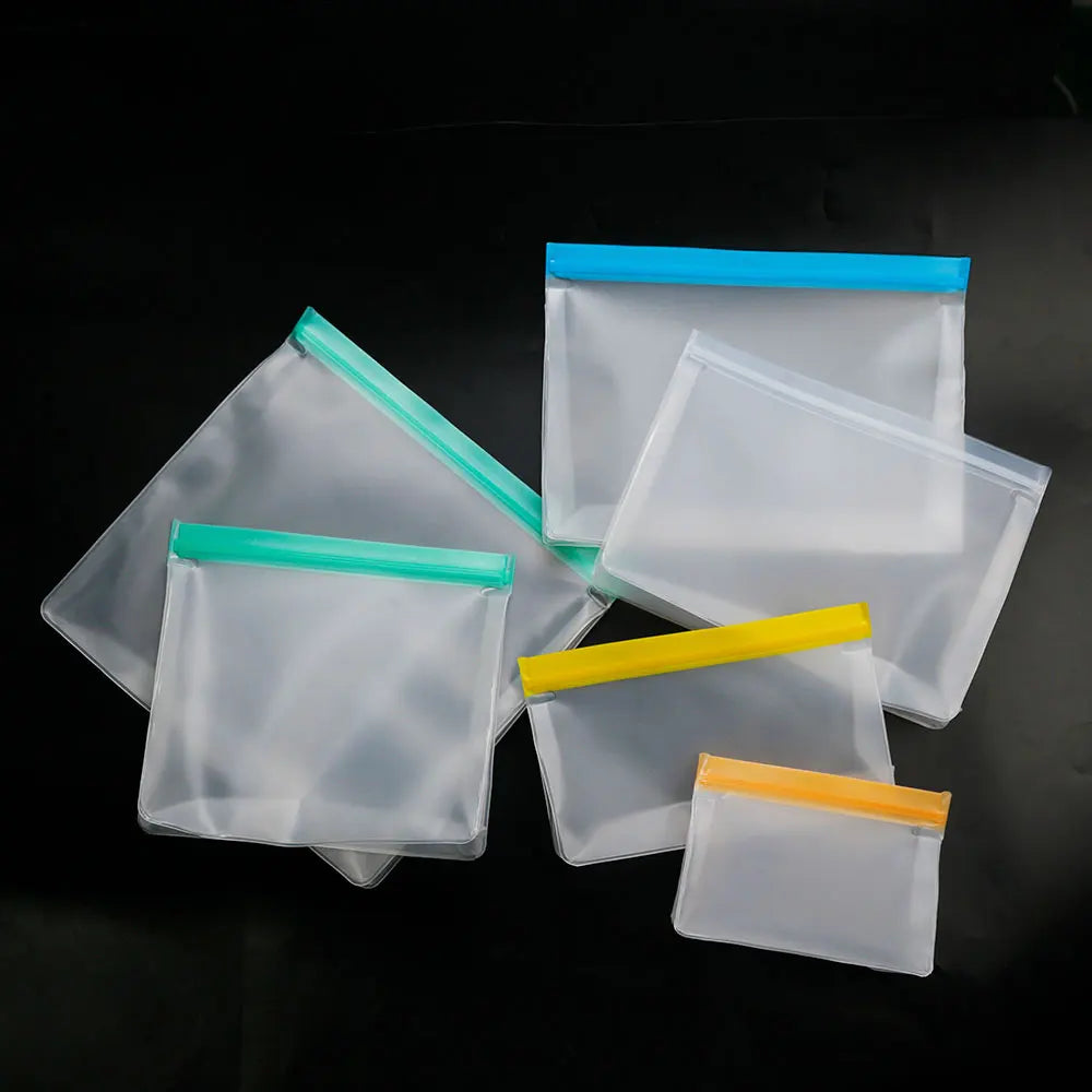 Set of reusable silicone food storage bags in assorted sizes with green, yellow, orange and blue seals