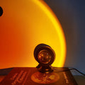 Sunset lamp projecting a golden glow on a wall