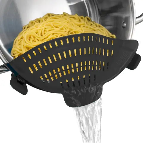 Adjustable silicone clip-on strainer draining pasta from a steel pot