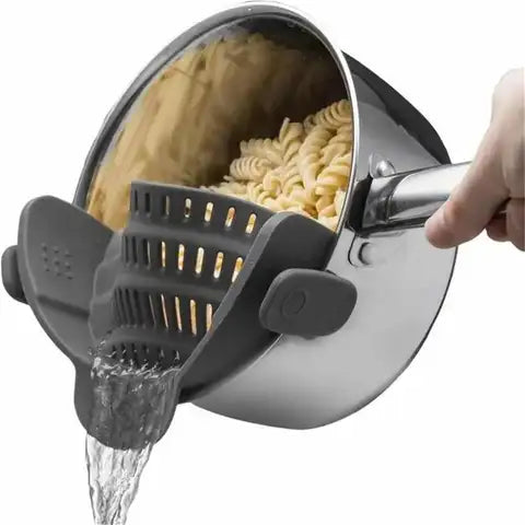 Clip-on silicone strainer attached to pot rim while pouring