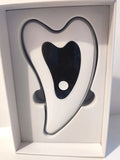 Heated vibrating gua sha facial massager device, heart-shaped white and black design